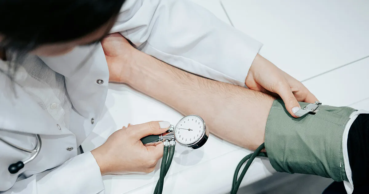 La recepción de un centro de salud español con una tarjeta sanitaria y un formulario de cita en el mostrador